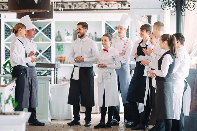 restaurant-manager-his-staff-terrace-interacting-head-chef-restaurant@ (1)